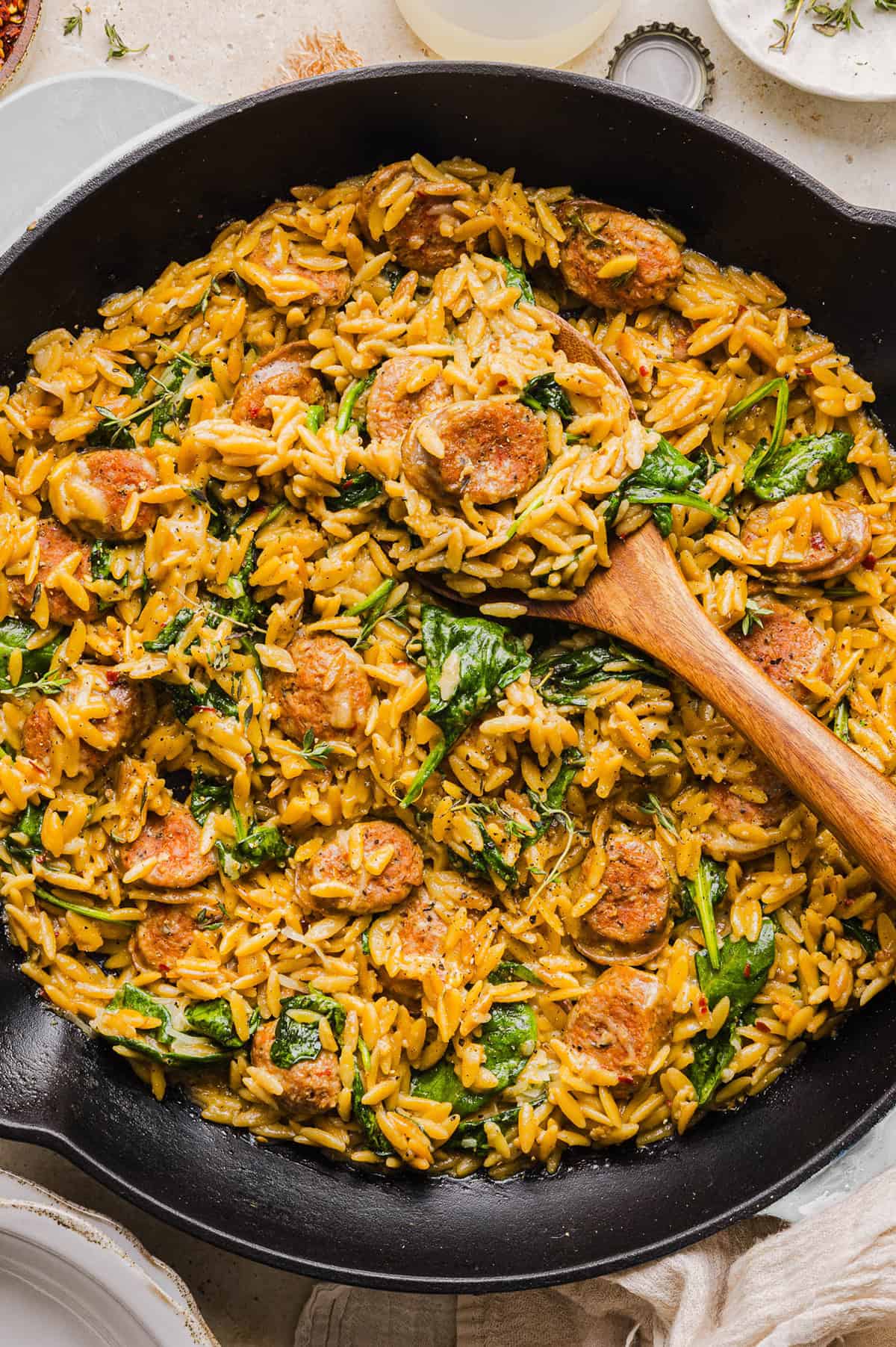 This Creamy Chicken Sausage Orzo Skillet is the perfect weeknight meal loaded with flavorful chicken sausage, tender orzo, tons of garlic and leafy spinach easily made in just 20 minutes all in one pan!ย ย
